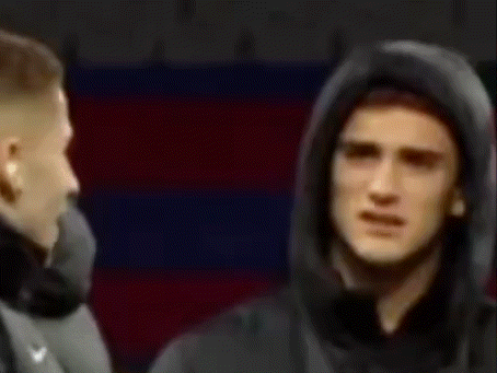 Man In Hooded Jacket Standing In Front Of Man In Suit GIF