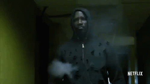 Man in Hooded Jacket Walking Hallway