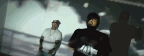 Man in Hooded Shirt Dancing With Man in White Shirt