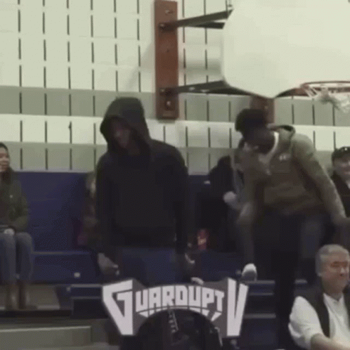 Man in Hooded Sweatshirt at Guardupv Sign