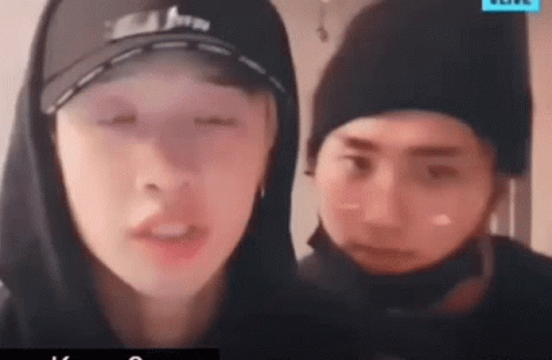Man in Hoodie and Hat Beside Man in Hat