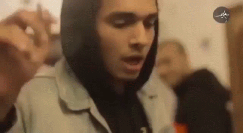 Man in Hoodie Holding Microphone