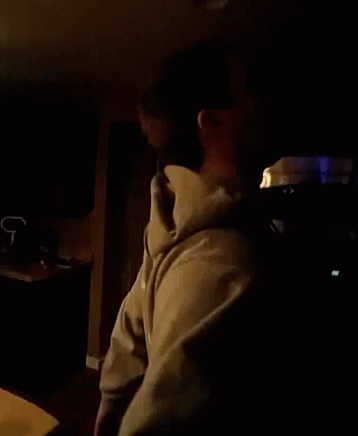 Man in Hoodie in Dark Room