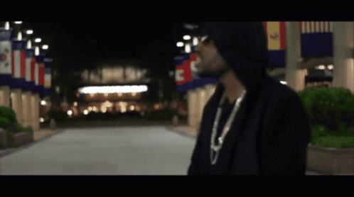 Man In Hoodie In Front Of Building With C GIF