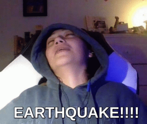 Man in Hoodie Laying Down Saying Earthquake