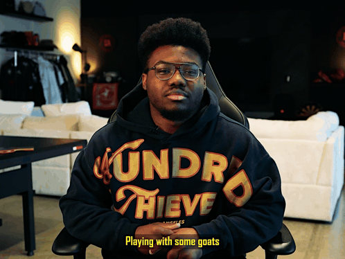 Man in Hoodie Playing with Goats