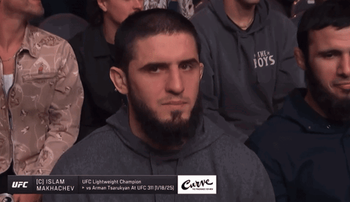 Man In Hoodie Saying The Toys Sits In Crowd GIF