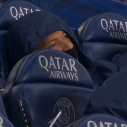Man In Hoodie Sitting In Qatar Airways Stadium Seat GIF