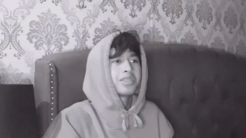 Man in Hoodie Sitting on Couch