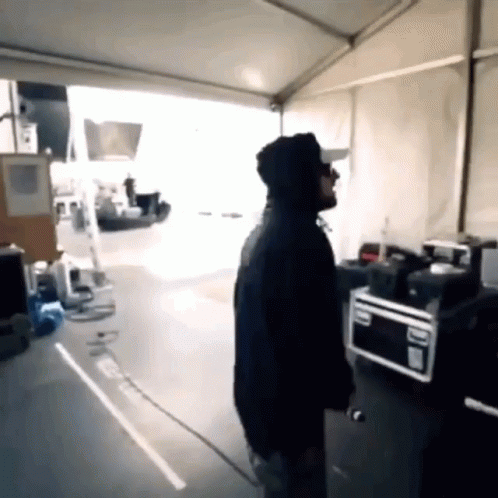 Man in Hoodie Standing Near Microwave