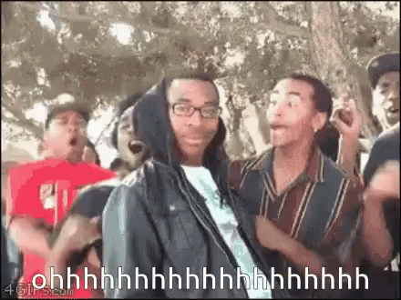 Man In Hoodie Surrounded By Crowd Saying Ohh GIF