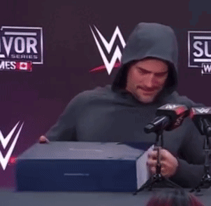 Man in Hoodie Thumbs Up at Microphones
