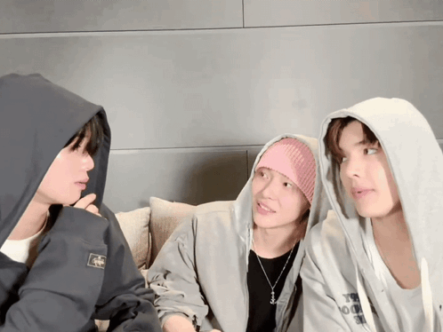 Man In Hoodie With A Talks To Two Men GIF