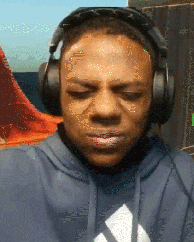 Man in Hoodie With Adidas Logo and Headphones