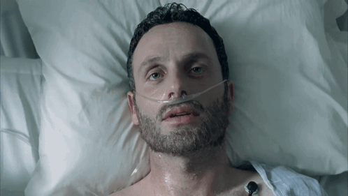 Man In Hospital Bed With Oxygen Mask GIF