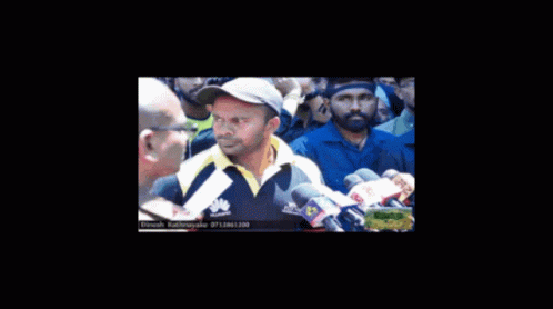 Man in Huawei Shirt Talks to Reporter