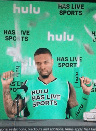 Man In Hulu Has Live Sports Jersey Holding Two Boxes GIF