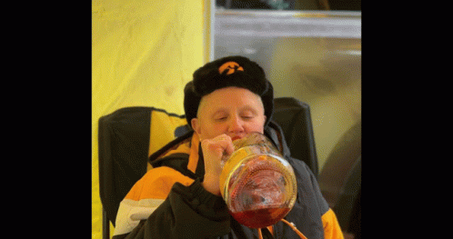 Man in Iowa Hat Drinking