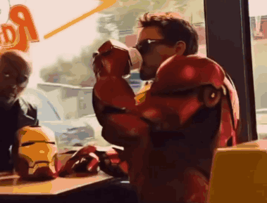 Man in Iron Man Costume Drinking From Cup