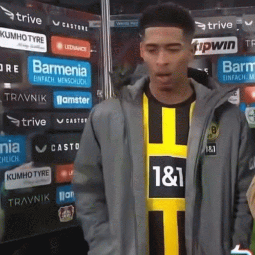 Man in Jacket and Yellow Black Shirt Number 11
