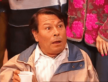 Man in Jacket Holding Cup Making Funny Face