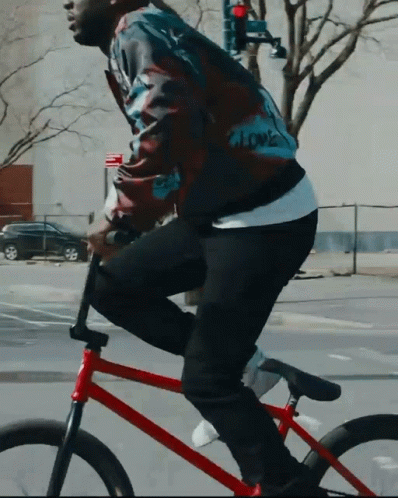 Man in Jacket Saying Love Riding Red Bike