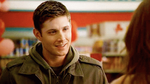 Man In Jacket Smiling Talking To Woman GIF