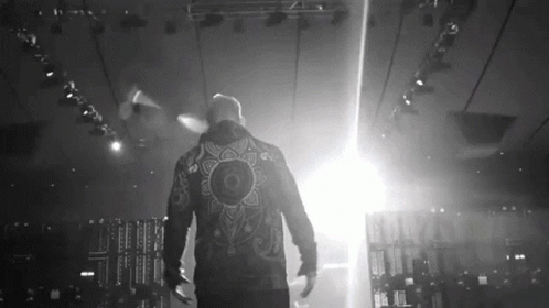 Man in Jacket With Mandala Walking on Stage