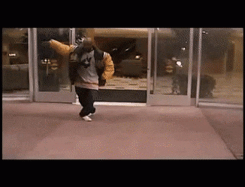 Man in Jacket With Number 4 Walking Through Doorway