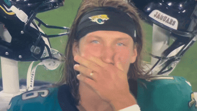 Man in Jaguars Headband Covering Mouth
