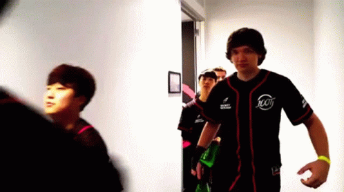 Man in Jersey Number 100 Walking Down Hallway
