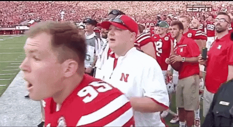 Man in Jersey Number 95 in Front of Football Crowd