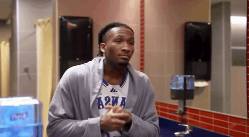 Man In Jersey Saying A2wa In Bathroom GIF