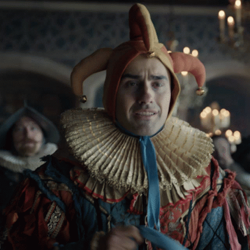 Man In Jester Costume With Blue Tie GIF