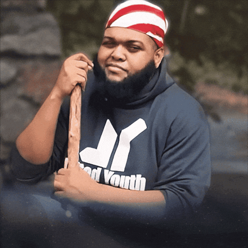 Man in Jr Brand Youth Sweatshirt Holding Stick
