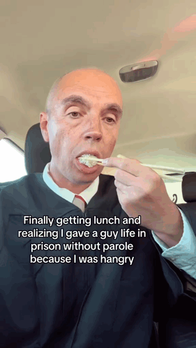Man in Judge's Robe Eating Food