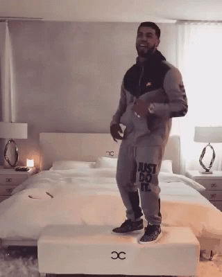 Man In Just Do It Outfit Standing On Stool GIF