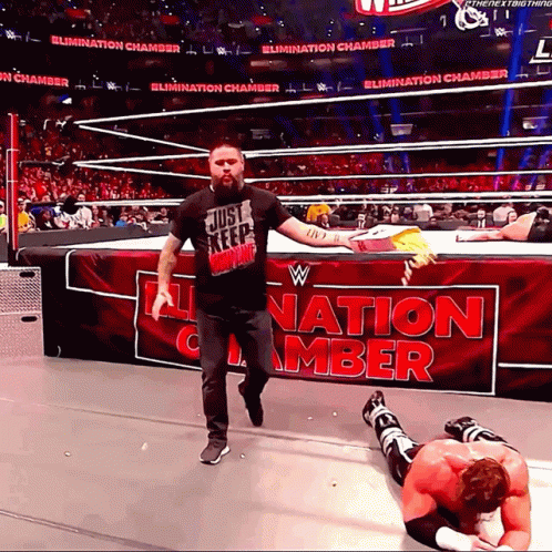 Man in Just Keep Walking Shirt at Elimination Chamber