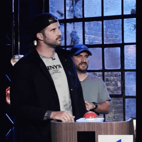 Man in Kani T-Shirt at Podium