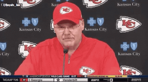 Man in Kansas City Hat in Front of Kansas City Logos