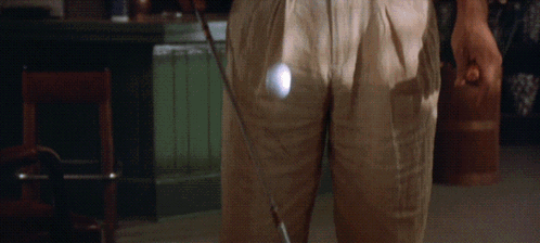 Man in Khaki Pants Holding Golf Club