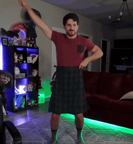 Man in Kilt and Red Shirt Dancing