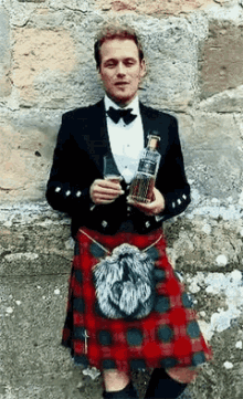 Man in Kilt and Tuxedo Holding Whiskey and Glass