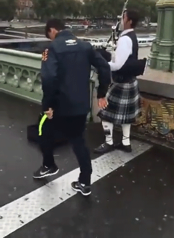 Man in Kilt Holding Hands With Man in Rugby Jacket