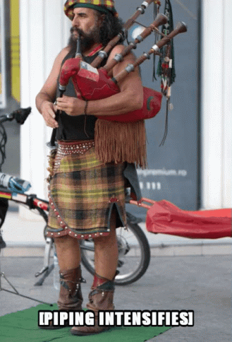 Man in Kilt Playing Bagpipe Piping Intensifies