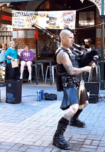 Man In Kilt Playing Bagpipes In Front Of Los Angeles Sign GIF