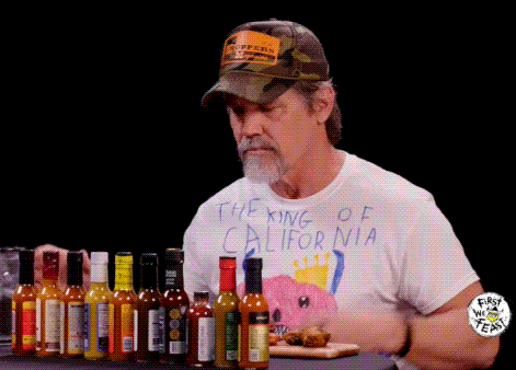 Man in King of California T-Shirt Holding Hot Sauce