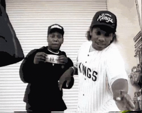 Man in Kings Jersey Holding Dollar Bill