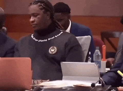 Man In Kings Reigning Sweater Sitting At Laptop GIF