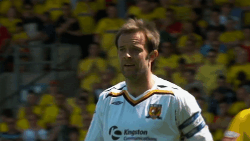 Man in Kingston Communications Jersey on Soccer Field